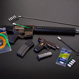 A .22-caliber rifle, magazines, Bore-Whips and Bore-tips arranged on a dark work surface.