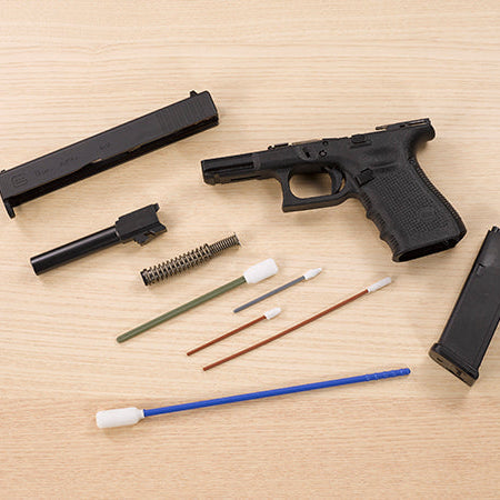 •	Field-stripped 9mm Glock with Bore-tips cleaning products