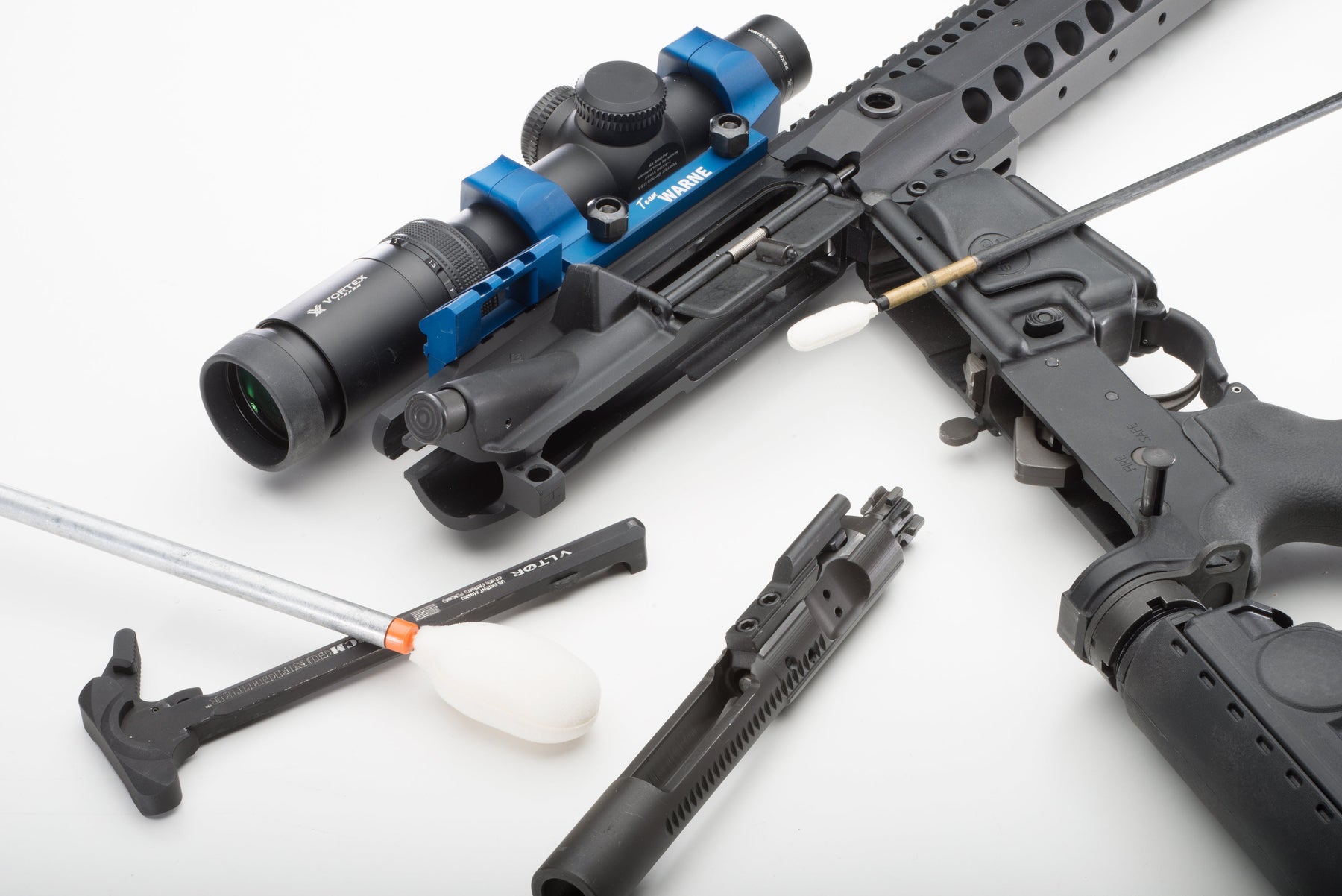 Disassembled AR-pattern rifle with reusable firearm cleaning Bore-tips and cleaning rods