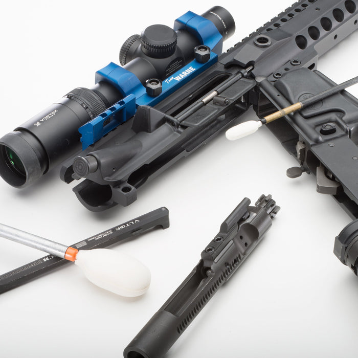 Disassembled AR-pattern rifle with reusable firearm cleaning Bore-tips and cleaning rods